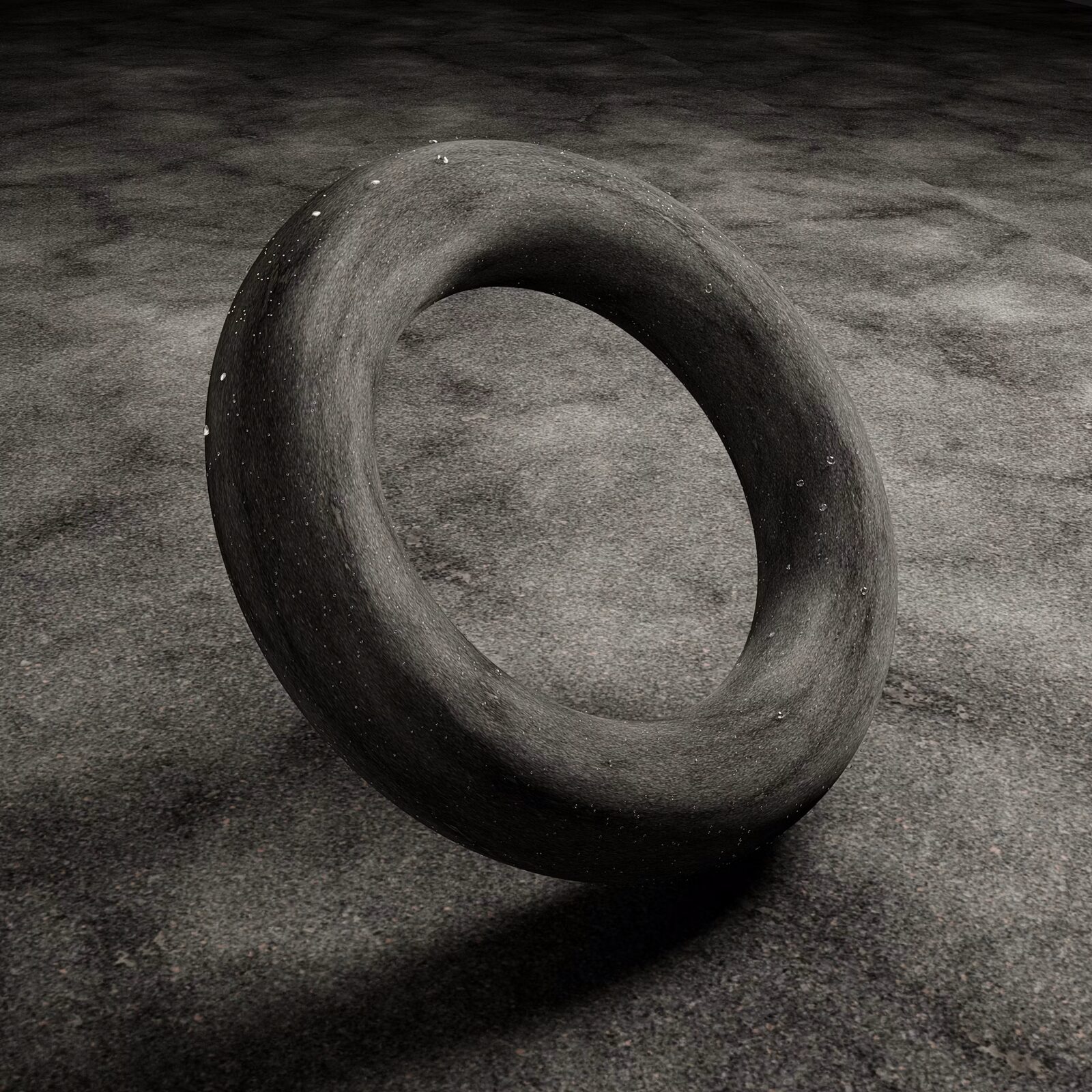 Sepia rubber ring standing on bare ground, tube-like form